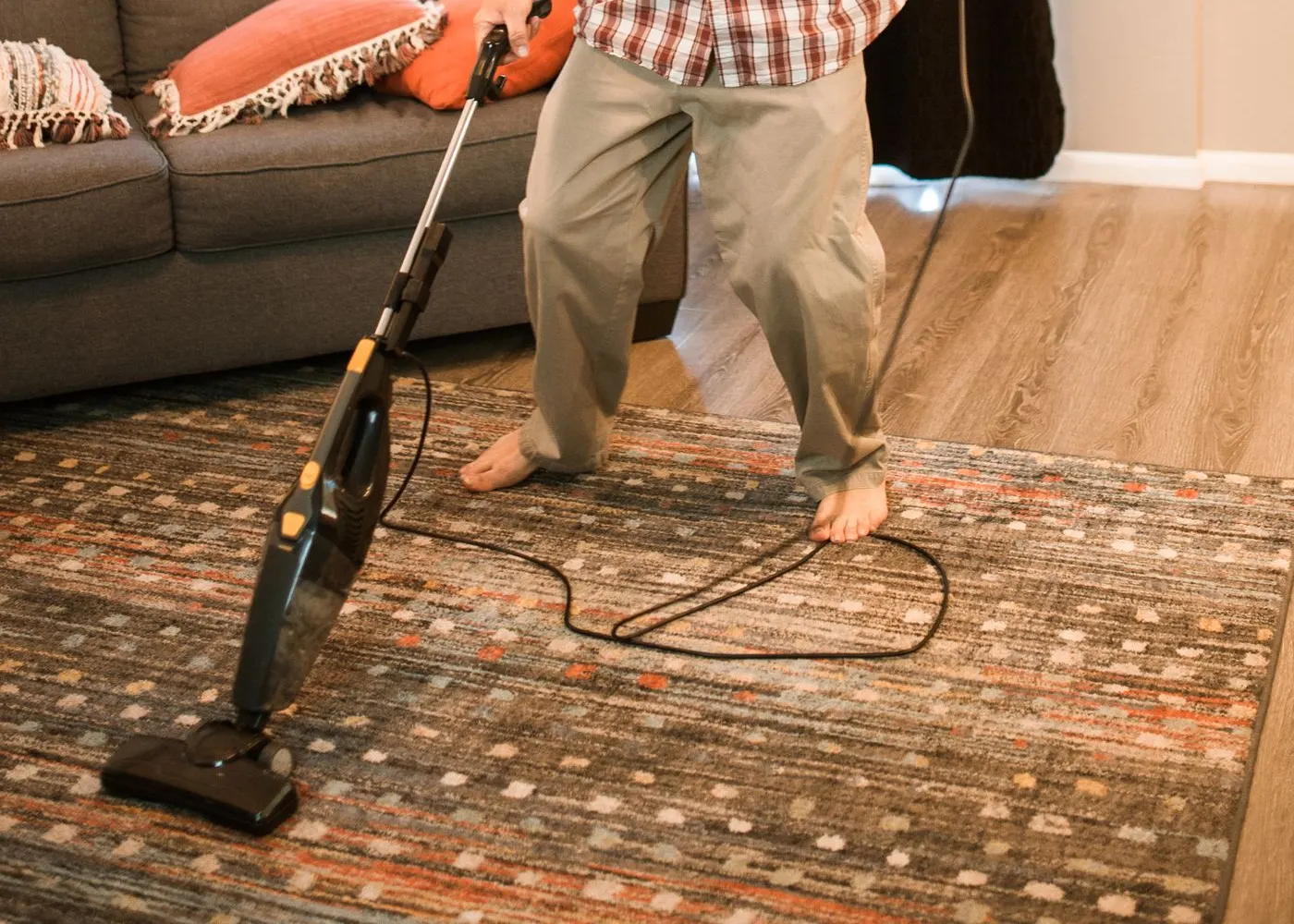 A person vacuuming a carpet
