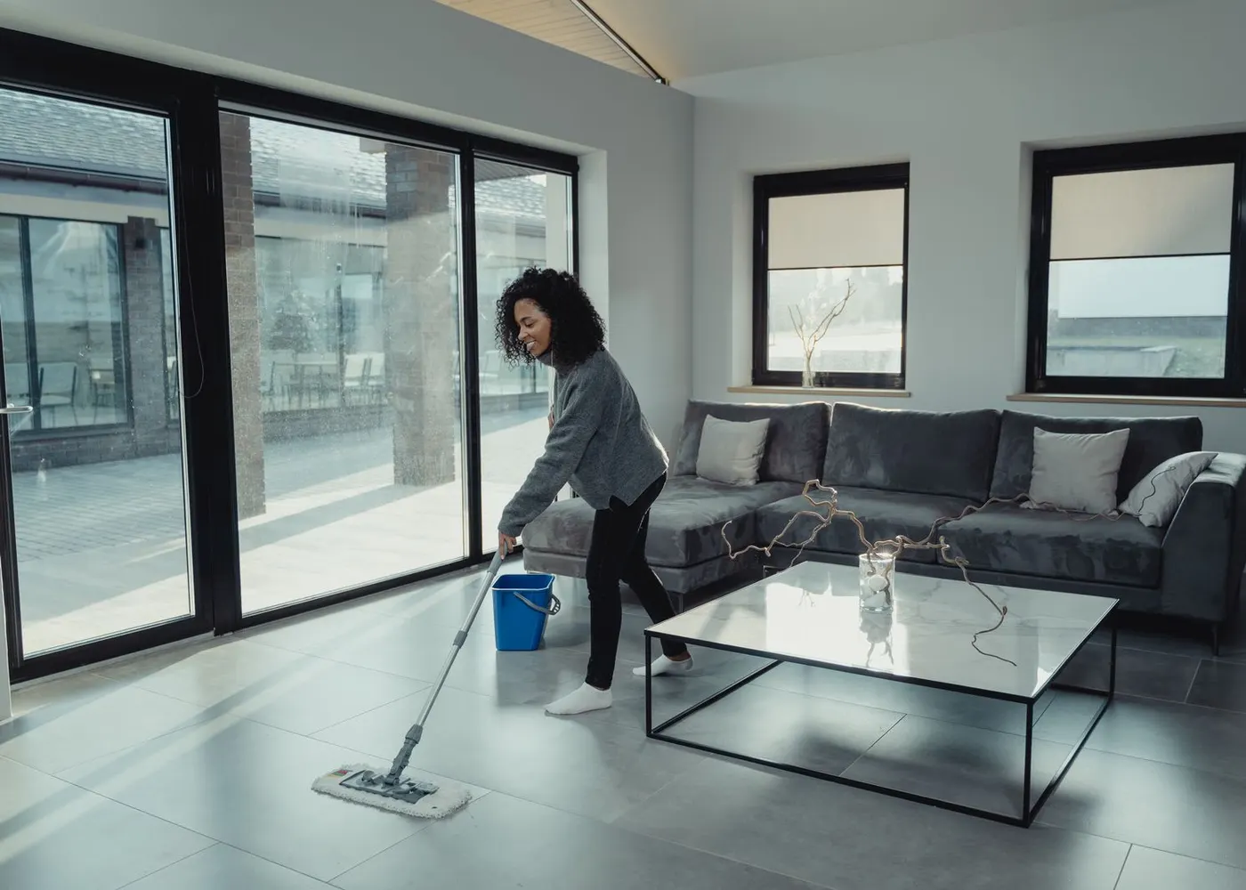 A person mopping a living room floor